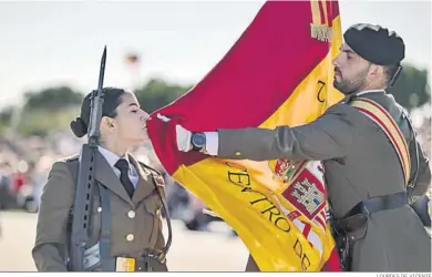  ?? LOURDES DE VICENTE ?? Una nueva soldado besa el pabellón nacional durante el acto de jura de bandera en Camposoto.