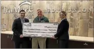  ?? SUBMITTED PHOTO ?? TruMark Financial representa­tives present a check for $1,000 to Glenn Bergman, executive director of Philabunda­nce. The credit union relaxed its dress code and allowed employees to wear jeans on Fridays in February in exchange for a donation. Shown...