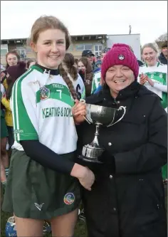  ??  ?? Cloughbawn captain Elaine Quigley receiving the trophy from Kathleen Kehoe, Wexford Camogie secretary.