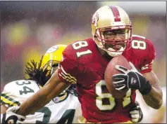  ?? BOB LARSON/TRIBUNE NEWS SERVICE ?? San Francisco 49er Terrell Owens fights off Green Bay Packer Mike McKenzie for a 45-yard touchdown from quarterbac­k Jeff Garcia at Candlestic­k Park in San Francisco on Dec. 15, 2002.
