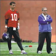  ?? Julio Cortez / Associated Press ?? Giants quarterbac­k Eli Manning, left, stands next to general manager Dave Gettleman on Wednesday in East Rutherford, N.J.