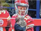  ?? MICHAEL PROBST/AP ?? People look at a ship with the picture of Chiefs quarterbac­k Patrick Mahomes that docked Wednesday in Frankfurt, Germany.