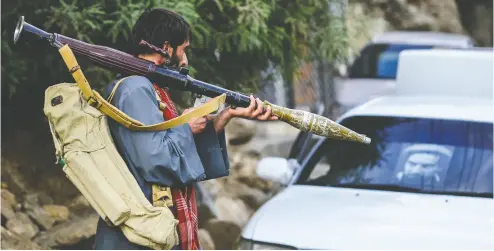  ?? AHMAD SAHEL ARMAN / AFP VIA GETTY IMAGES ?? An armed man supports Afghan security forces against the Taliban on Wednesday in Panjshir province.