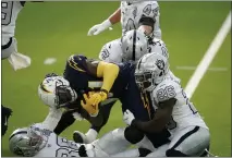  ?? ALEX GALLARDO — THE ASSOCIATED PRESS ?? Los Angeles Chargers running back Kalen Ballage is hauled down during the first half against the Las Vegas Raiders on Nov. 8.