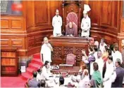  ??  ?? Opposition members protest in the well of Rajya Sabha in New Delhi