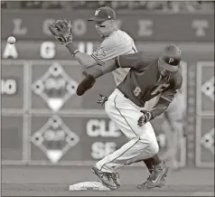  ?? Gene J. Puskar / The Associated Press ?? Pittsburgh’s Starling Marte (6) advances to second on a sacrifice fly by Josh Harrison as Milwaukee second baseman Hernan Perez takes the late relay throw during the fourth inning of Tuesday’s game in Pittsburgh.