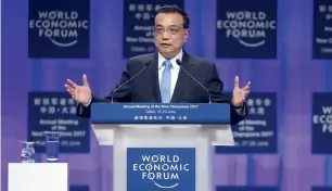  ?? — Reuters ?? Li Keqiang delivers an opening speech at the World Economic Forum in Dalian on Tuesday.