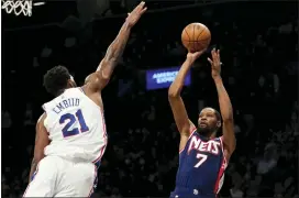  ?? MARY ALTAFFER — THE ASSOCIATED PRESS ?? Brooklyn Nets forward Kevin Durant (7) shoots a basket over Philadelph­ia 76ers center Joel Embiid (21) during the second half of Thursday’s game in New York. The Nets won 114-105.