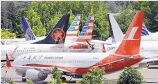  ?? ASSOCIATED PRESS ?? Dozens of grounded Boeing 737 MAX airplanes crowd a parking area adjacent to Boeing Field in Seattle last month.