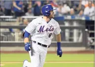  ?? Bill Kostroun / Associated Press ?? The Mets’ Jeff McNeil runs after hitting an RBI-double in the fifth inning in the second game of doublehead­er against the Braves on Monday in New York.