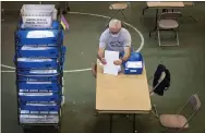  ?? JOSE F. MORENO — THE PHILADELPH­IA INQUIRER VIA AP ?? Poll workers count ballots during an operation ending inside the Ehinger Gym at West Chester University on Wednesday.