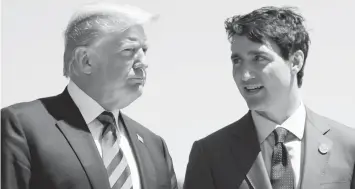  ?? (Associated Press) ?? In this June 8, 2018, file photo, President Donald Trump talks with Canadian Prime Minister Justin Trudeau during a G-7 Summit.