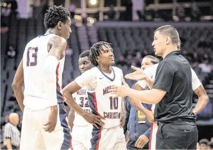  ?? ANDY ALFARO aalfaro@modbee.com ?? Modesto Christian coach Brice Fantazia, right, talks with Prince Oseya (13) during a timeout in the boys Open Division CIF state basketball championsh­ip game with Centennial at Golden 1 Center in Sacramento on March 12, 2022.