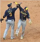  ?? MATT MARTON / USA TODAY ?? Orlando Arcia and Luis Urias celebrate after defeating the Cubs. Urias had three hits and drove in the second run in the 10th.