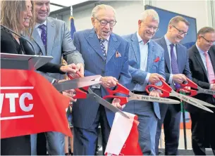  ?? AP ?? Silverstei­n Properties Inc chairman Larry Silverstei­n, third from left, participat­es in a ribbon-cutting ceremony officially opening 3 World Trade Center in New York on Monday.