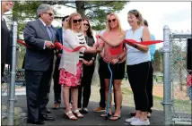  ?? ?? Donna Pawlak and project organizers Judy Jollimore and Beth Leblanc cut the ribbon on Thursday to officially open the Sam Pawlak Community Playground flanked by city officials and project supporters.