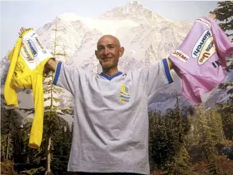  ??  ?? Holding the yellow and pink jerseys, and still the last rider to do the Giro-Tour double