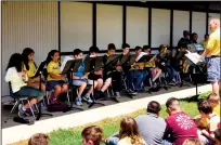  ??  ?? Music teacher Mr. Shorts led the band in a concert in the courtyard.