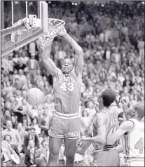  ?? THE ASSOCIATED PRESS FILE ?? North Carolina State’s Lorenzo Charles (43) scores on a dunk at the buzzer for the upset win over heavily favored Houston in the NCAA Tournament championsh­ip game April 4, 1983, in the Pit.