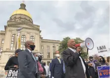  ?? Jeff Amy / Associated Press ?? African Methodist Episcopal Church Bishop Reginald Jackson protests restrictiv­e voting measures last month in Atlanta.