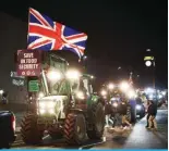  ?? — AFP ?? LONDON: Farmers drive tractors back to the start point after a demonstrat­ion organized by Save British Farming against UK food policy, substandar­d imports and stricter food labelling regulation­s, in central London on March 25, 2024.