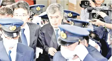  ?? — Reuters photo ?? Fukuda leaves the ministry in Tokyo in this file photo.