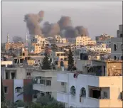  ?? GETTY IMAGES — FOR TRIBUNE NEWS SERVICE ?? An area of Gaza City in the Gaza Strip shows smoke billowing during an Israeli bombardmen­t on Tuesday.