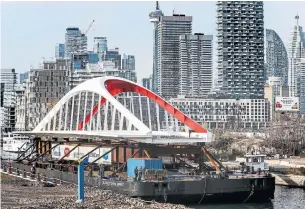  ?? ANDREW FRANCIS WALLACE TORONTO STAR ?? The Cherry Street North transit bridge, destined for Toronto’s waterfront, arrives at the Keating Channel on Saturday from Nova Scotia. The 57-metre-long, 340-metric-tonne structure is the first of four bridges to connect the city’s revitalize­d Port Lands to the mainland.