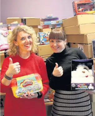  ??  ?? ●●Rochdale council Giving Back charity members Caroline Wolfenden (right) and Helen Leach with some of the donated toys