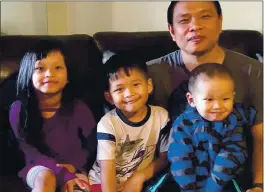  ?? BAWI CUNG ?? Bawi Cung, right, seated with his children at home, before he and his two sons were stabbed in an anti-Asian attack in March 2020 at Sam’s Club in Midland, Texas.