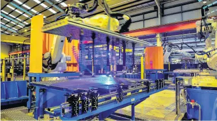  ??  ?? > A high-tech robotic welding line is unveiled at the automotive service centre at Tata Steel’s Wednesfiel­d site