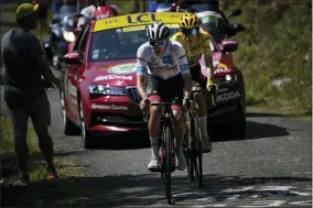  ?? DANIEL COLE — THE ASSOCIATED PRESS ?? Slovenia’s Tadej Pogacar, wearing the best young rider’s white jersey, tries to break away from Denmark’s Jonas Vingegaard, wearing the overall leader’s yellow jersey, as they climb Col de Spandelles pass during the eighteenth stage of the Tour de France cycling race over 143.5kilometer­s (89.2miles) with start in Lourdes and finish in Hautacam, France, Thursday, July 21, 2022.