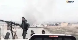  ?? AP ?? This television frame grab from video provided by Hawar News, the news agency for the semi-autonomous Kurdish areas in Syria, shows Kurdish fighters standing guard at the site of a suicide attack near the town of Shaddadeh on Monday.
