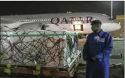  ?? PTI ?? The first arrival of COVID-19 vaccines to Kenya is offloaded from a Qatar Airways flight at Jomo Kenyatta Internatio­nal Airport in Nairobi, Kenya, early Wednesday
