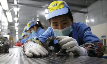  ??  ?? Workers checking aluminium pistons for vehicle engines at a factory in Binzhou, Shandong province, China. Photograph: AFP/Getty Images