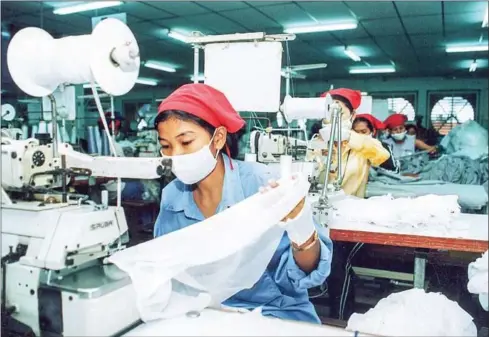  ?? KHEM SOVANNARA/CAMBODGE SOIR/AFP ?? Female workers of a garment factory stitch clothing for export in the outskirts of Phnom Penh. Most products go to the EU and the US.