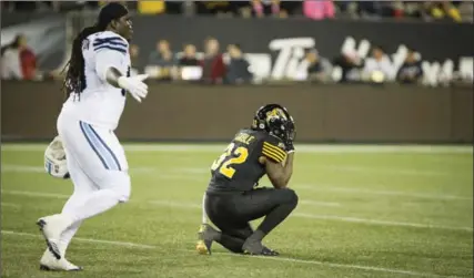  ?? PETER POWER, THE CANADIAN PRESS ?? Hamilton Tiger-Cats running back C.J. Gable remains on one knee after his team was defeated by the Toronto Argonauts, 43-35 in overtime, on Saturday.