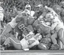  ?? RICH SCHULTZ/AP ?? Eagles quarterbac­k Jalen Hurts (1) scores on a ‘tush push’ against the Miami Dolphins on Oct. 22 in Philadelph­ia. The Eagles defeated the Dolphins 31-17.