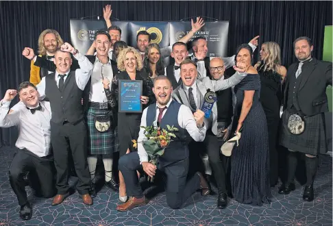  ?? ?? RECOGNITIO­N: Last year’s Business of the Year Carnoustie Golf Links with their gong. Picture by Kim Cessford.