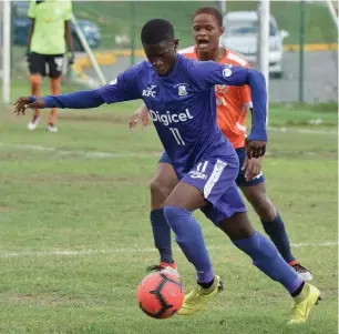  ??  ?? Kingston College’s Ronaldo Robinson (front) gets by Dunoon Technical’s Quala Rose during their ISSA/Digicel Manning Cup match at the Breezy Castle Field in downtown Kingston. Kingston College were leading 2-0 when the referee called a halt to the match in the 55th minute because of lightning in the area, on Tuesday, September 17.