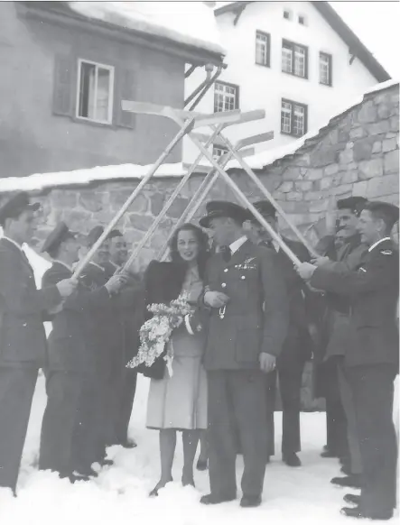  ??  ?? A hockey-stick honour guard is formed by players from the RCAF Flyers for the wedding of team member Hubert Brooks to Birthe (Bea) Grontved at St. Moritz, Switzerlan­d, on Feb. 9, 1948.