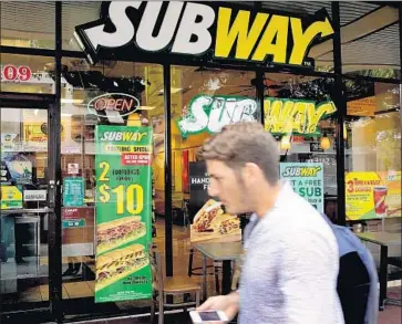  ?? Joe Raedle Getty Images ?? HUNDREDS of Subway franchisee­s sent a strongly worded letter warning company officials that the decadeold promotion of a $4.99 footlong sandwich beginning in January could force some stores to close.