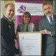  ??  ?? The Earl hands over a certificat­e to Nicola Smith and Iain Morrison to mark the University of the Highlands and Islands on becoming a licensed DofE centre.