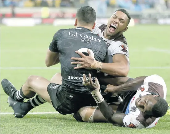  ?? Zimbio ?? Dallin Watene Zelezniak of New Zealand is tackled by Vodafone Fijian Bati winger Suliasi Vunivalu and centre Taane Milne during the Rugby League World Cup quarterfin­al at Wellington Regional Stadium on November 18, 2017.Photo: