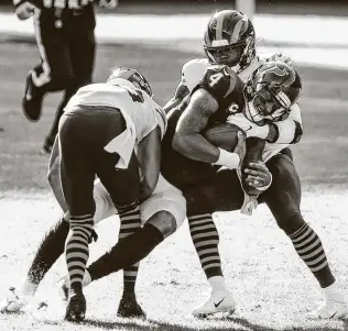  ?? Brett Coomer / Staff photograph­er ?? Texans quarterbac­k Deshaun Watson, the team’s second-leading rusher with 38 yards Sunday, gets tackled by the Bears’ Kyle Fuller, left, and Danny Trevathan during the second quarter.