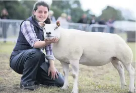  ??  ?? Country life Fiona Burke and a Beltex-bred sheep champion last year