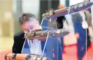  ?? /Reuters ?? Reassuring result: A man looks at models of Lockheed Martin’s PAC-3, PAC-3 MSE and THAAD missiles at the Japan Aerospace 2016 air show in Tokyo, Japan.