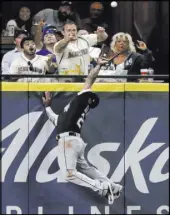  ?? Ted S. Warren The Associated Press ?? White Sox left fielder Leury Garcia prepares to rob Mitch Haniger of a ninth-inning home run Saturday in the Mariners’ 5-0 loss at Safeco Field.