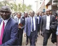  ??  ?? NAIROBI: Opposition leader Raila Odinga, center, arrives at the Supreme Court. —AP