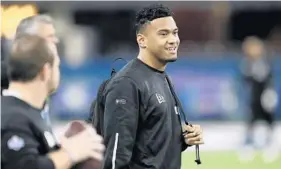  ?? CHARLIE NEIBERGALL/AP ?? Former Alabama quarterbac­k Tua Tagovailoa watches a drill during the NFL scouting combine in February.